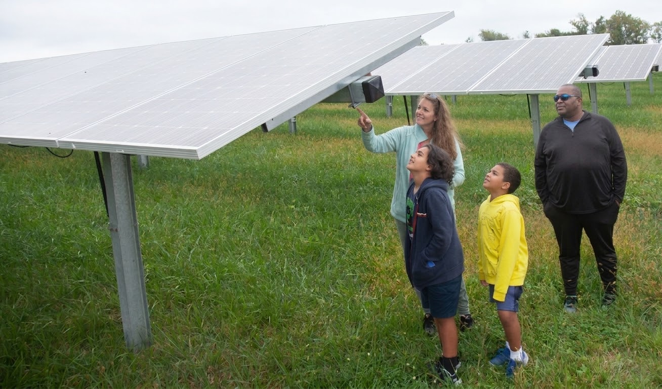 Family at community solar farm