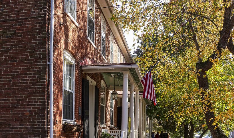 Brick houses with porches on a tree-lined street in the Chestertown historic district