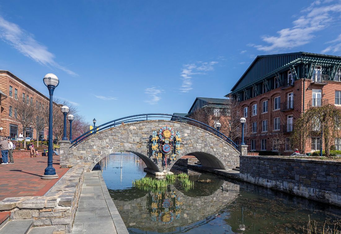 The stone arch of Community Bridge reflected in Carroll Creek, Frederick