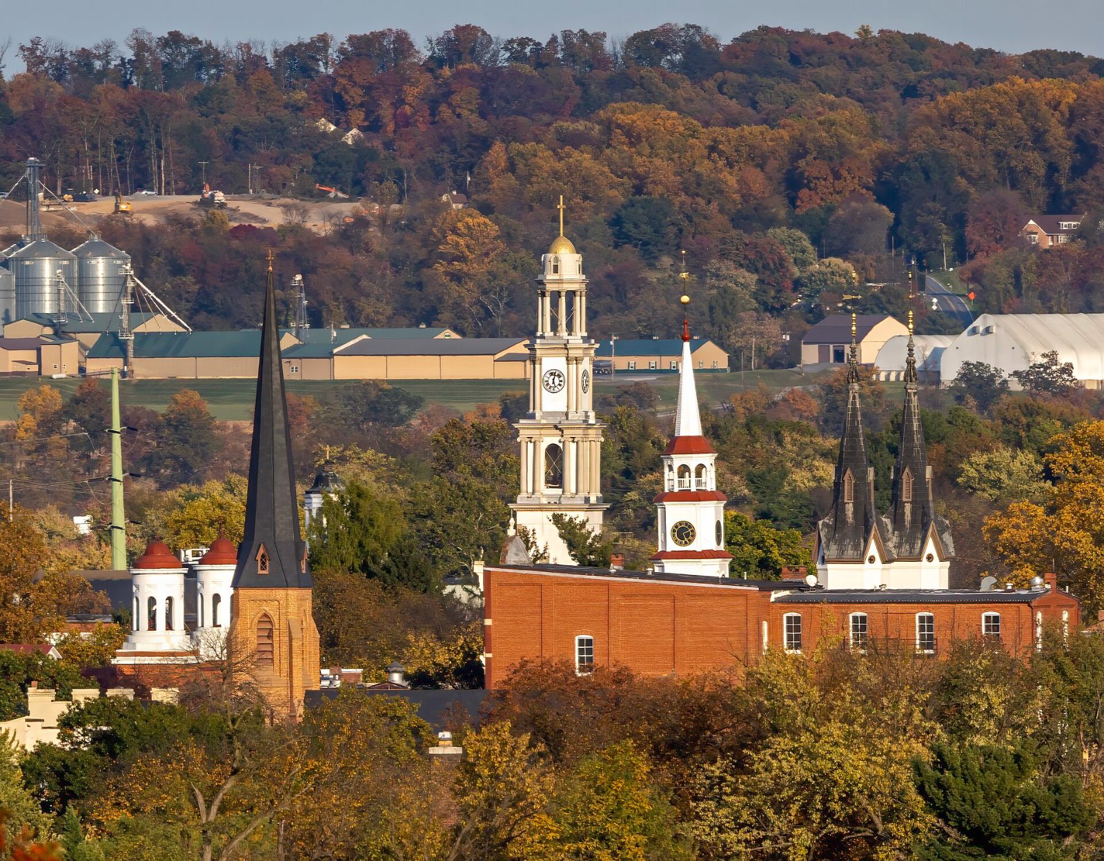 The church steeples of downtown Frederick rising in front of the wooded Catoctin ridge in autumn